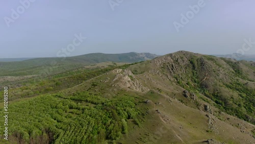 Flying above Macin Mountains, the oldest mountains in Romania on a beautiful spring day with clear skies. photo