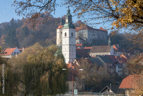 Skofia Loka, Slovenia. Campanile della chiesa di San Giacomo sullo sfondo del castello. photo