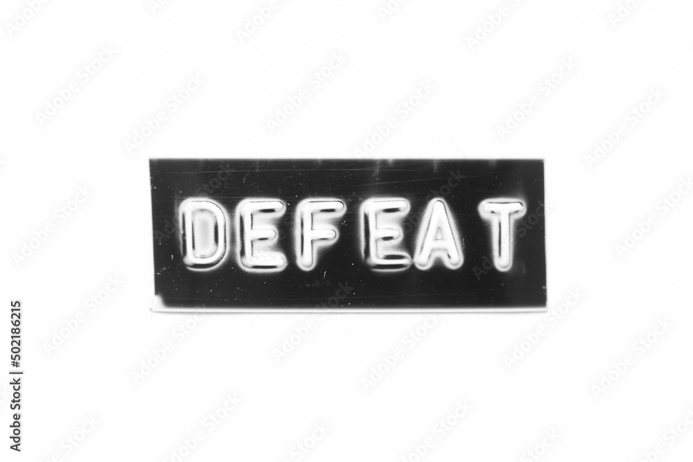Black color banner that have embossed letter with word defeat on white paper background Black color banner that have embossed letter with word defeat on white paper background