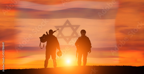 Silhouette of Soldier in sunset background . Flag of Israel. National holiday .