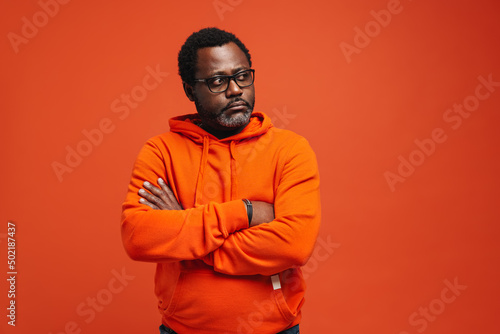 Obraz na plátně Black sad man in eyeglasses posing with arms crossed