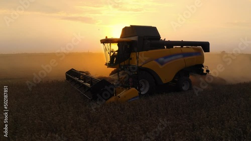 Combine harvesting wheat at sunset. Agriculture Machinery Technology Food Modification Crop Farming Concept