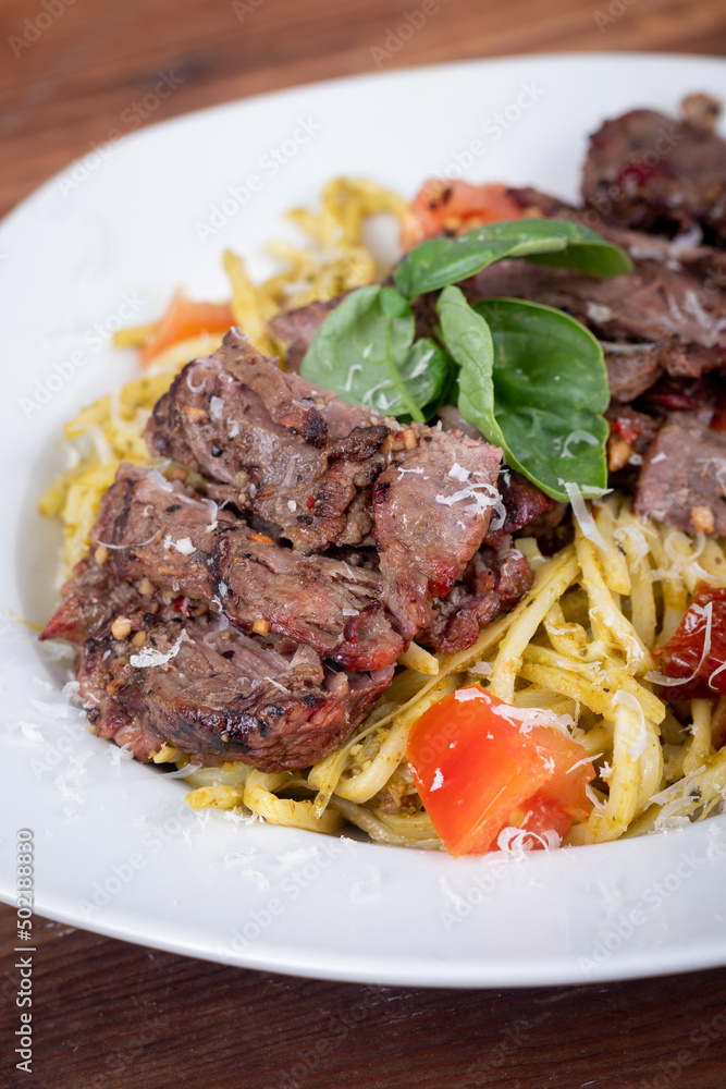 Grilled flank steak over basil pesto keto pasta Grilled flank steak over basil pesto keto pasta