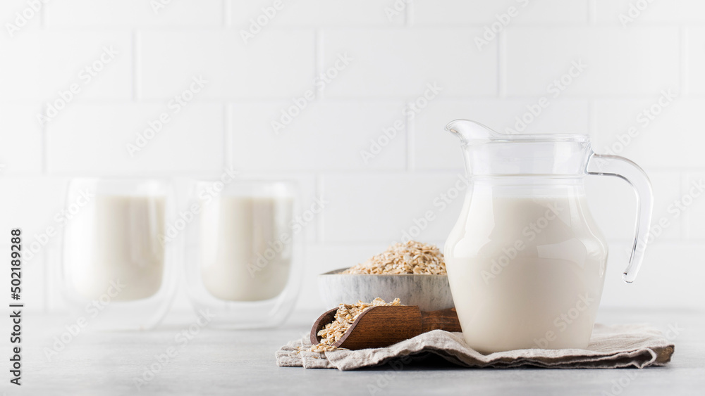 Vegan oat milk, non-dairy alternative milk in a jug. Vegan non-dairy alternative milk. Copy space. Vegan oat milk, non-dairy alternative milk in a jug. Vegan non-dairy alternative milk. Copy space.
