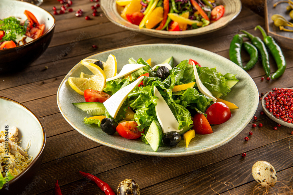 Portion of fresh greek salad on wooden table