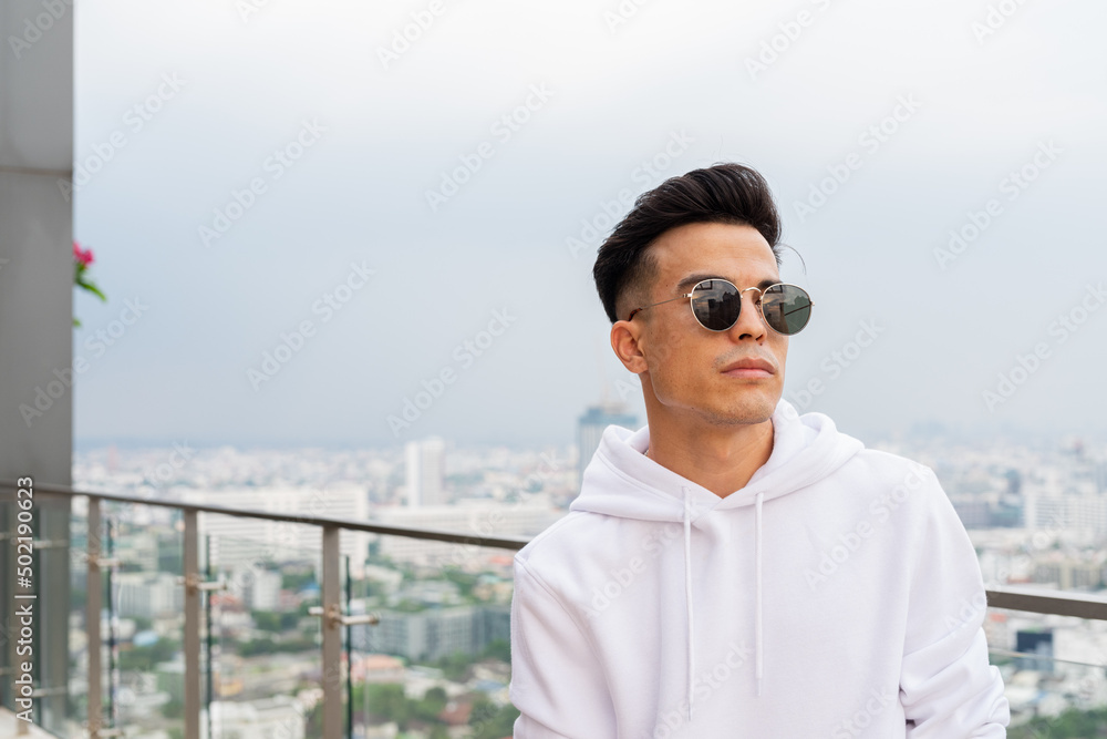 Portrait of handsome young cool man in city wearing sunglasses Portrait of handsome young cool man in city wearing sunglasses