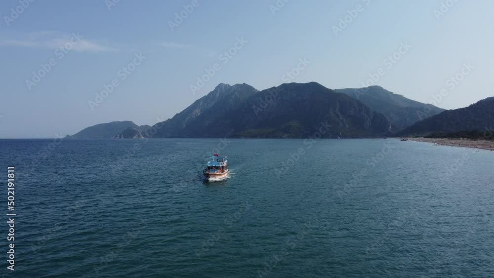 Air view from top to bottom of a sailing boat with tourists in the blue sea. High quality 4k footage Air view from top to bottom of a sailing boat with tourists in the blue sea. High quality 4k footage