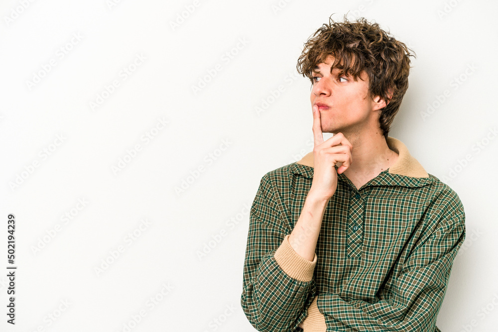 Young caucasian man isolated on white background looking sideways with doubtful and skeptical expression. Young caucasian man isolated on white background looking sideways with doubtful and skeptical expression.
