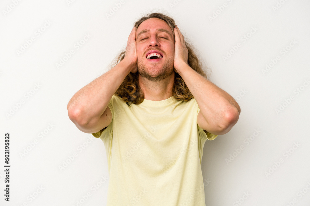 Young caucasian man isolated on white background laughs joyfully keeping hands on head. Happiness concept. Young caucasian man isolated on white background laughs joyfully keeping hands on head. Happiness concept.