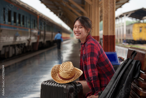 Young traveler woman looking for friend planning trip at train station. Summer and travel lifestyle concept