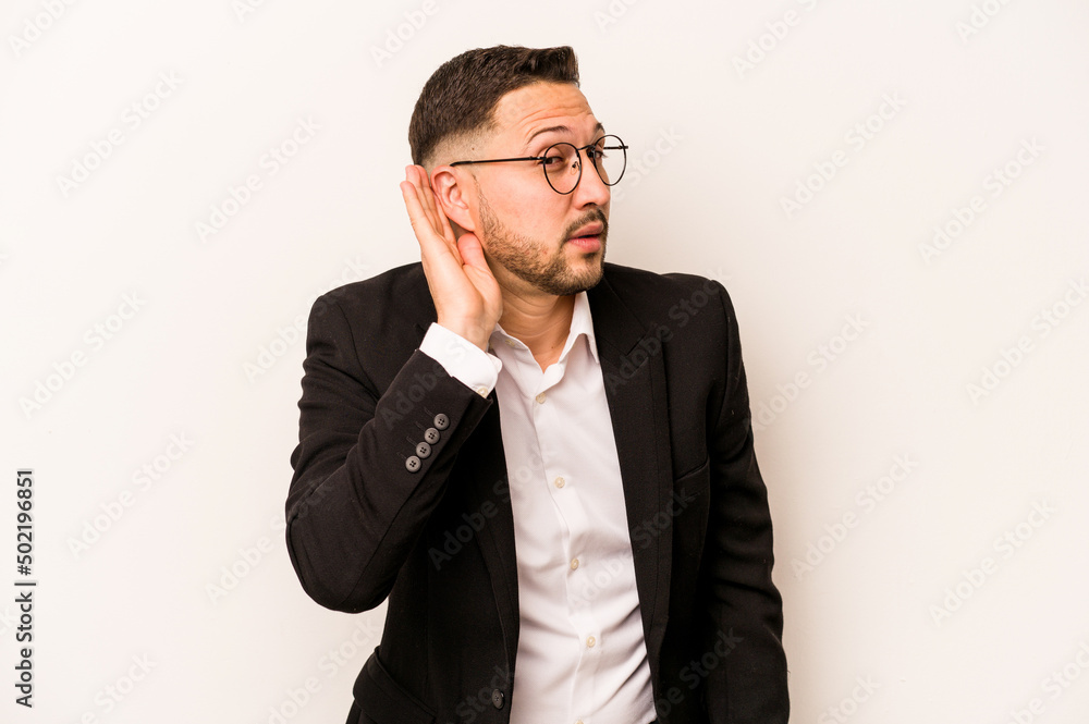 Business hispanic man isolated on white background trying to listening a gossip. Business hispanic man isolated on white background trying to listening a gossip.