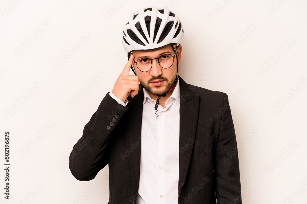 Business hispanic man wearing a helmet bike isolated on white background pointing temple with finger, thinking, focused on a task. Business hispanic man wearing a helmet bike isolated on white background pointing temple with finger, thinking, focused on a task.