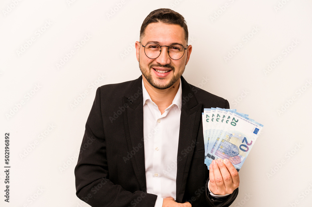 Business hispanic man holding banknotes isolated on white background laughing and having fun. Business hispanic man holding banknotes isolated on white background laughing and having fun.