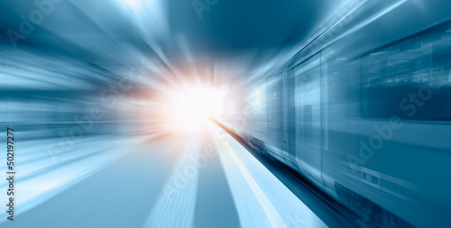 Fototapeta White high speed train runs on rail tracks -Train in motion