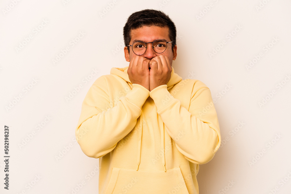 Young hispanic man isolated on white background biting fingernails, nervous and very anxious. Young hispanic man isolated on white background biting fingernails, nervous and very anxious.