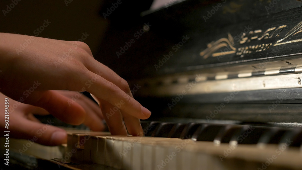 A young woman playing piano closeup. Piano hands pianist playing Musical instruments details with player hand closeup
