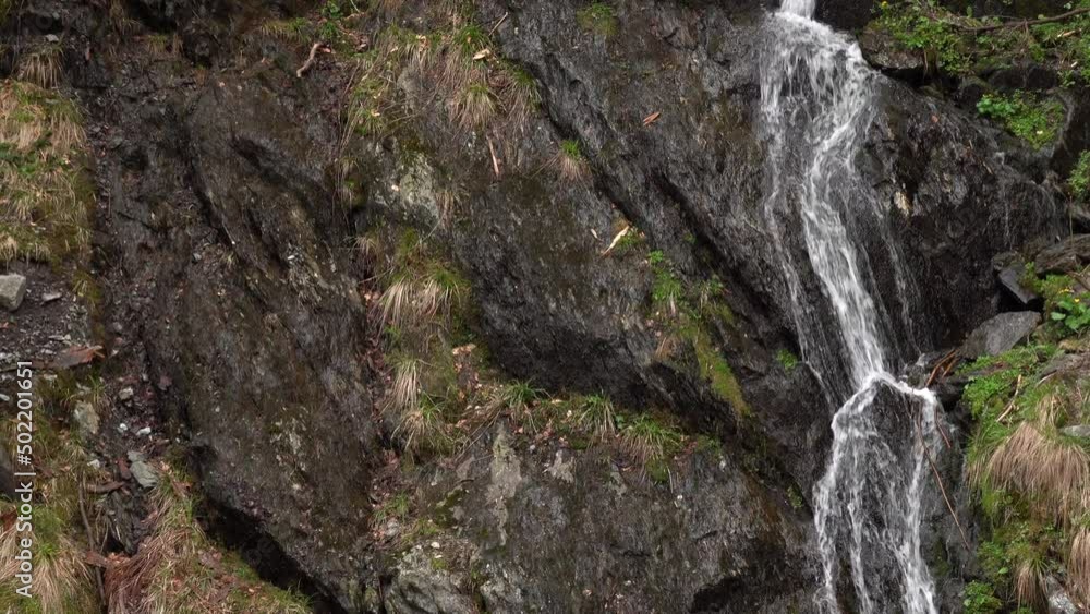 4k video. Beautiful view of a waterfall in the heart of the mountains during the spring. Landscape with amazing environment places of the world. 4k video. Beautiful view of a waterfall in the heart of the mountains during the spring. Landscape with amazing environment places of the world.