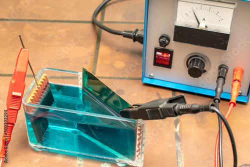 galvanic electrolysis of the solution with power supply photo