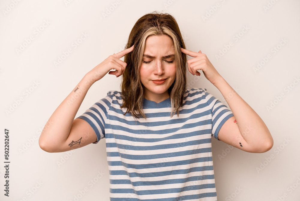 Young caucasian woman isolated on white background focused on a task, keeping forefingers pointing head. Young caucasian woman isolated on white background focused on a task, keeping forefingers pointing head.