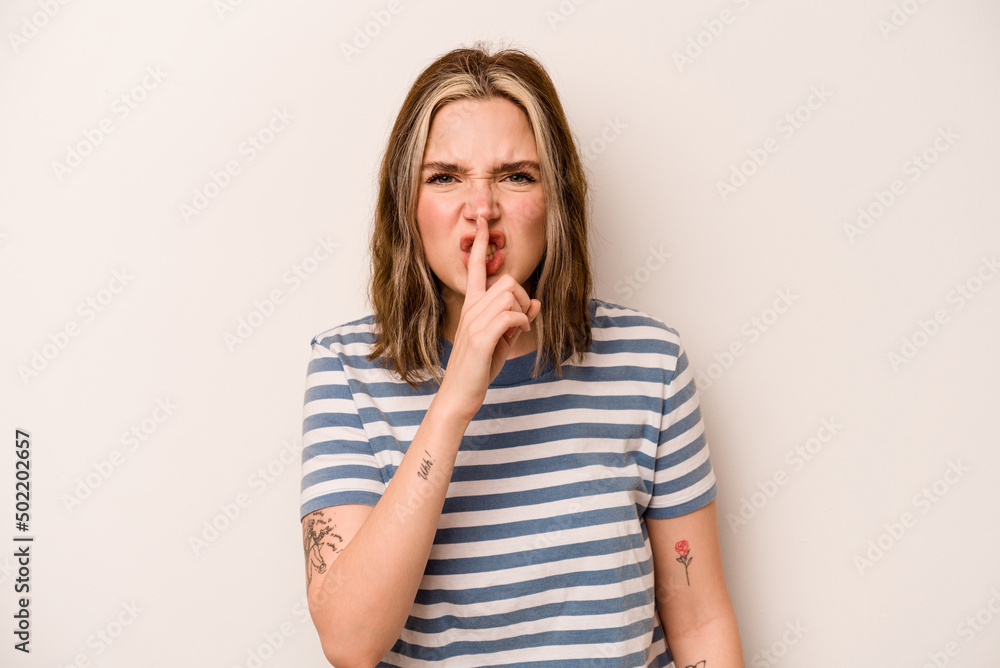 Young caucasian woman isolated on white background keeping a secret or asking for silence. Young caucasian woman isolated on white background keeping a secret or asking for silence.