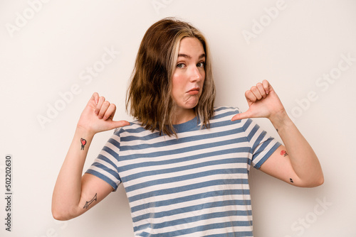Young caucasian woman isolated on white background feels proud and self confident, example to follow.
