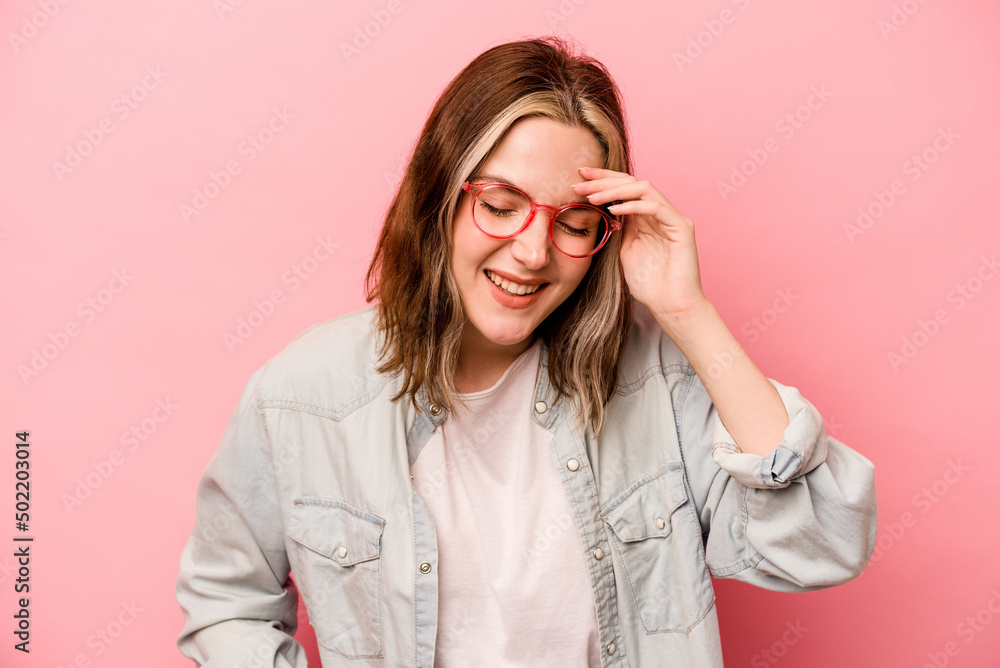 Young caucasian woman isolated on pink background joyful laughing a lot. Happiness concept. Young caucasian woman isolated on pink background joyful laughing a lot. Happiness concept.