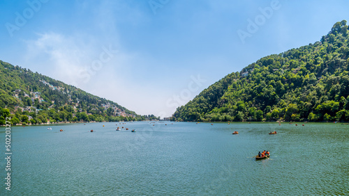 View of Nainital Lake from lakefront and mountains are in the background photo