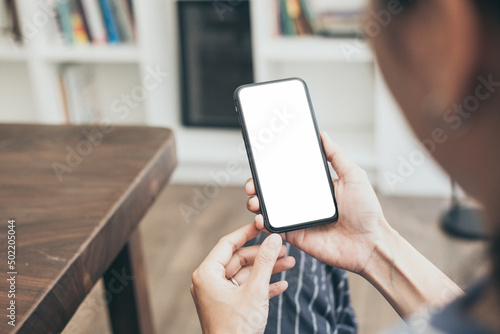 cell phone blank white screen mockup.hand holding texting using mobile on desk at office.background empty space for advertise.work people contact marketing business,technology