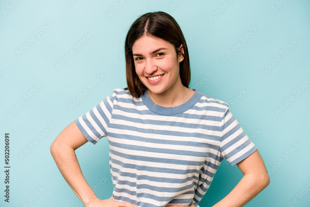 Young caucasian woman isolated on blue background happy, smiling and cheerful. Young caucasian woman isolated on blue background happy, smiling and cheerful.