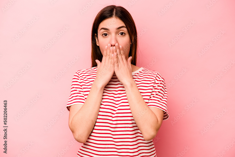 Young caucasian woman isolated on pink background shocked covering mouth with hands. Young caucasian woman isolated on pink background shocked covering mouth with hands.