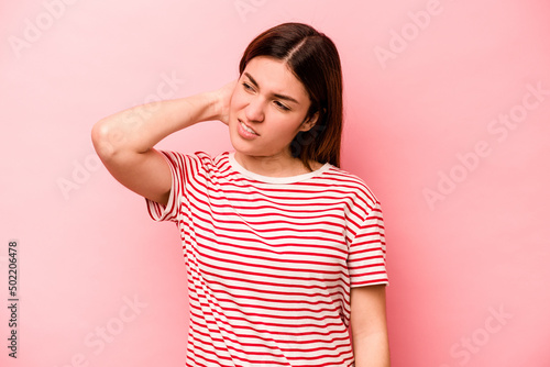 Young caucasian woman isolated on pink background tired and very sleepy keeping hand on head.