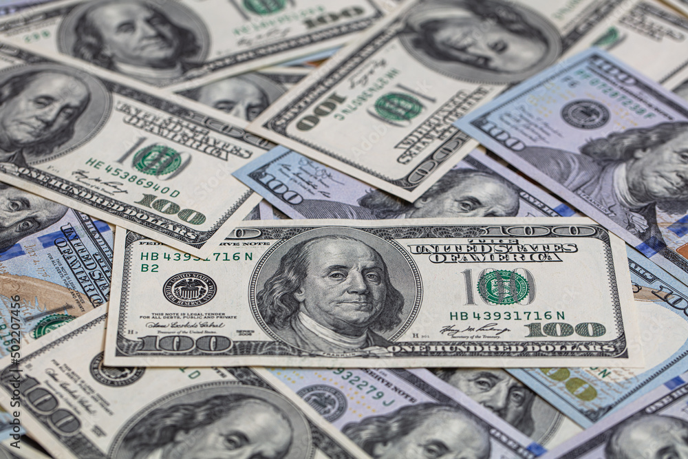 randomly layed 100 dollar bills background randomly layed 100 dollar bills background