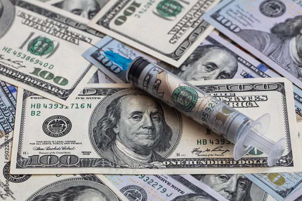 Fototapeta premium Syringe with 100 dollar banknote inside
