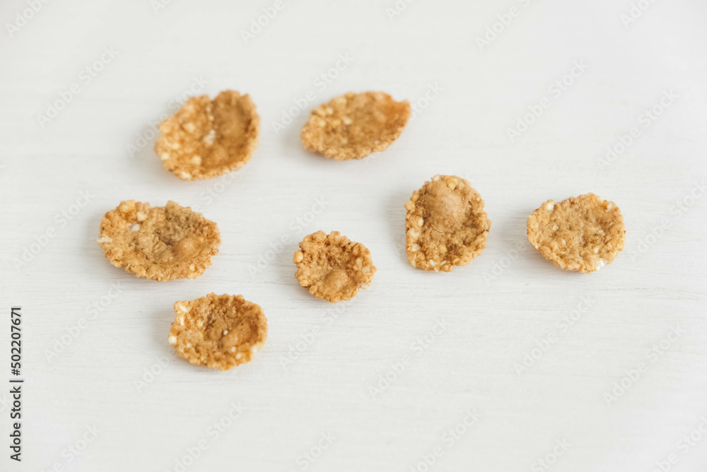 Crispy healthy dry cereal flakes on white background Crispy healthy dry cereal flakes on white background