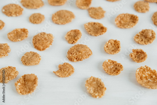 Crispy healthy dry cereal flakes on white background © Andriy