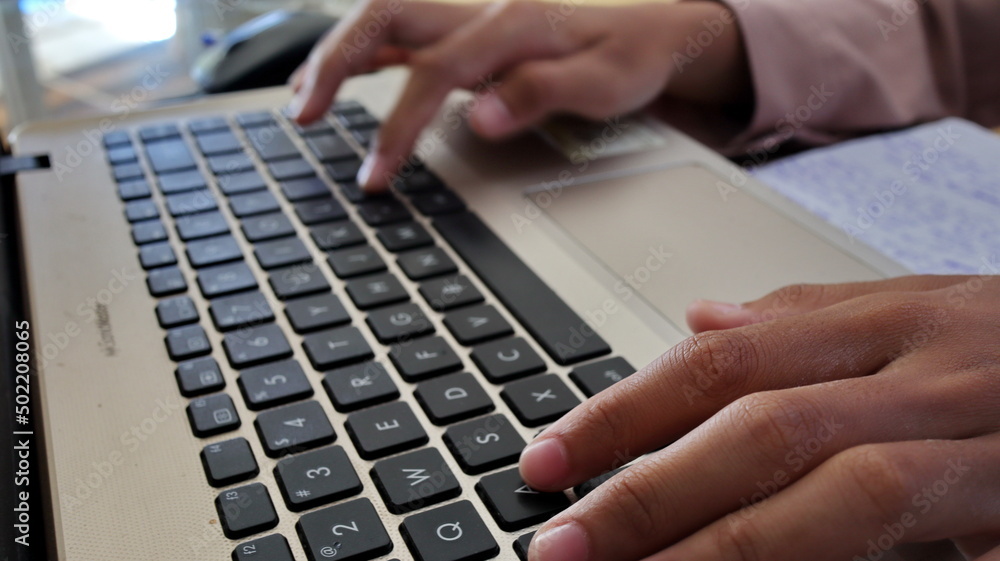 Closeup hands working and typing on laptop Closeup hands working and typing on laptop