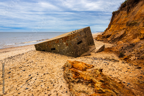 Fotografija World war 2 pill box fallen to the beach due to coastal erosion