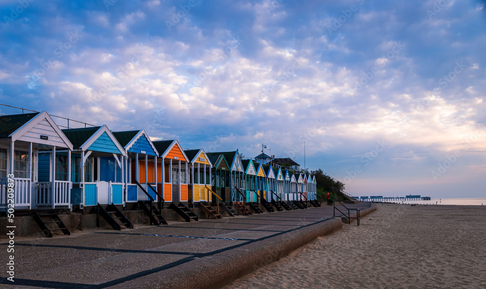 Naklejka premium Beach huts along the seafront on an early morning in May at Southwold Suffolk East Anglia England
