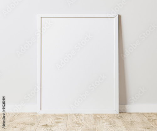 Blank Vertical white frame on wooden floor with white wall, 4:5 ratio - 40x50 cm, 16 x 20 inches, poster frame mock up, 3d rendering