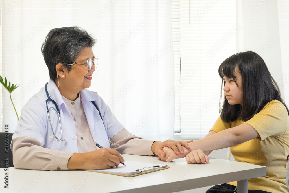 Depressed asian girl having consultation with psychologist at clinic. Depressed asian girl having consultation with psychologist at clinic.