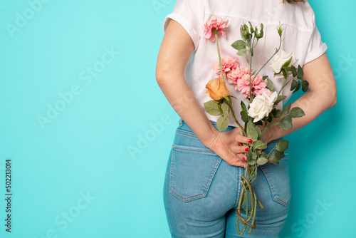 Back view young lady hold flowers spring holiday celebrate isolated on green background