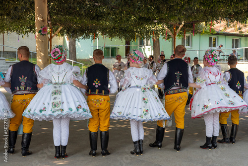 Rakvice, Czech Republic - June 2021. Beautiful women and men dancers in a celebration.Traditional Moravian feast. Young people in parade dressed in traditional Moravian folk costume.