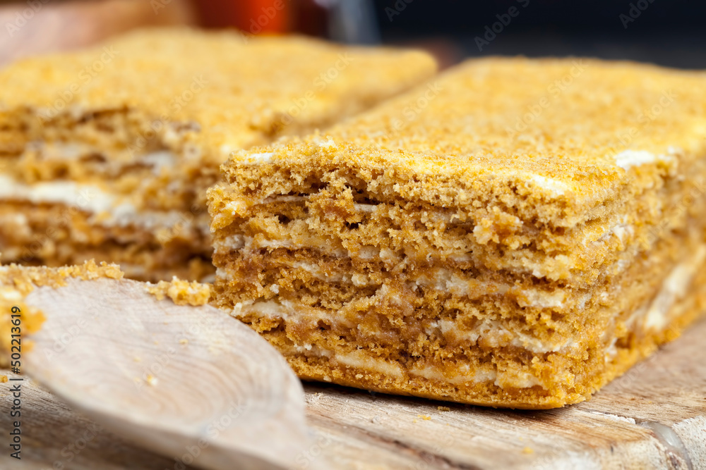 multi-layered cake made of soft cakes and buttercream with honey