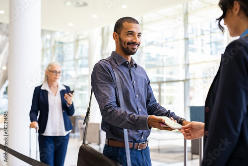 Fotografía Happy mixed race man showing electronic flight ticket
