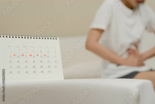 Menstruation  period cycle day of monthly  hurt asian young woman  female hand in stomachache  suffer from PMS premenstrual  belly or abdomen pain on bed at home. Health problem Inflammation in body