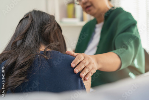 Psychology, depression. sad asian young woman cry about break up or divorce, consulting with psychologist ,psychiatrist while patient counseling mental with doctor at clinic. Encouraging, therapy.