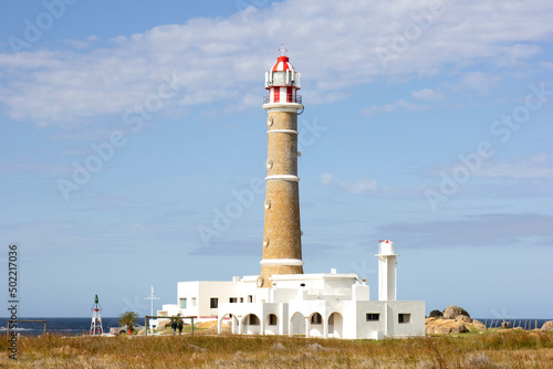 Landscape of Cabo Polonio, Uruguay. It is possible to see the fort and the lighthouse, the soil and the rocks. The building in red and white, is on the sea coast. Landmark, tourist point. photo