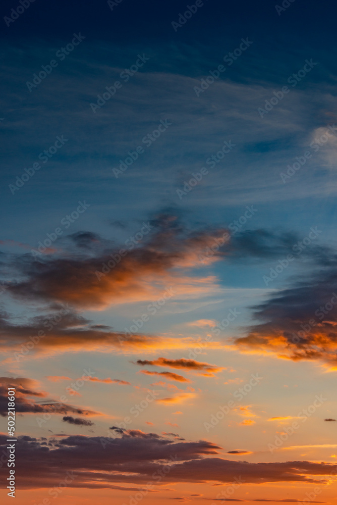 Cover page with gradient deep orange sky, illuminated clouds at bloody sunset as a background.