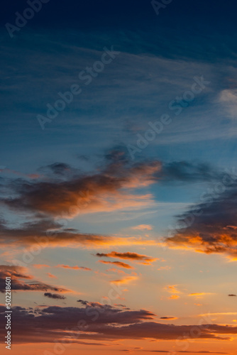 Cover page with gradient deep orange sky, illuminated clouds at bloody sunset as a background.