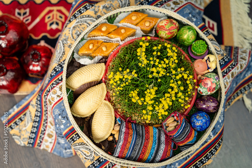 Novruz plate with Azerbaijan national pastry pakhlava and shekerbura and green semeni wheat grass  photo